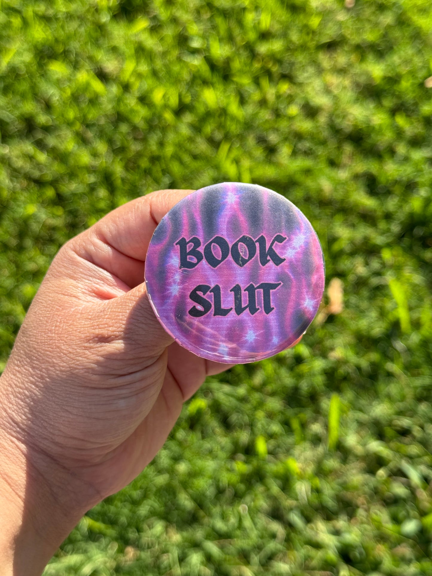 Button pin with text that says 'Book Slut'