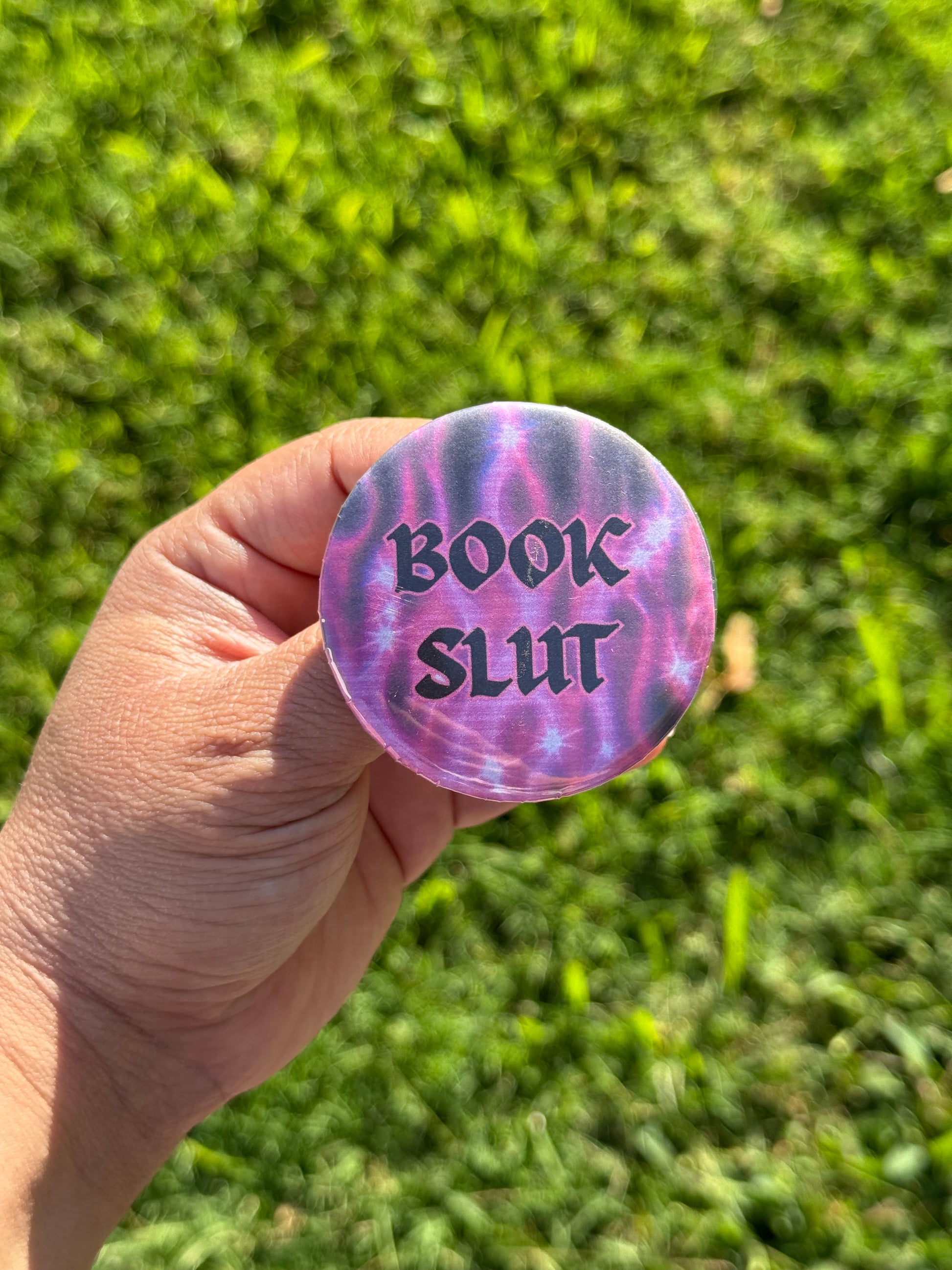 Button pin with text that says 'Book Slut'
